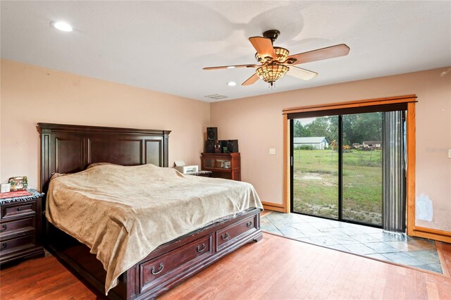 39427 Comstock Ln, Zephyrhills, FL 33540 - bedroom with wood finished floors, access to outside, recessed lighting, baseboards, and ceiling fan