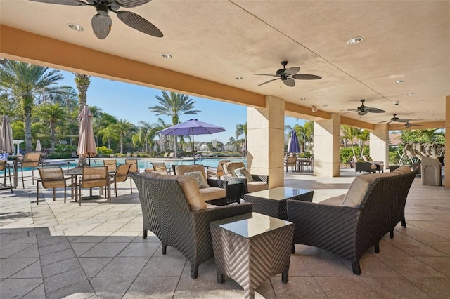view of patio / terrace with an outdoor living space, a ceiling fan, and a community pool