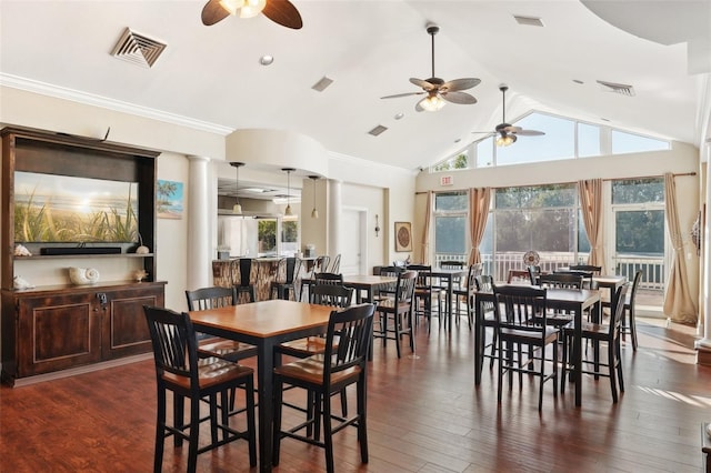 dining space featuring ceiling fan, visible vents, dark wood finished floors, and vaulted ceiling