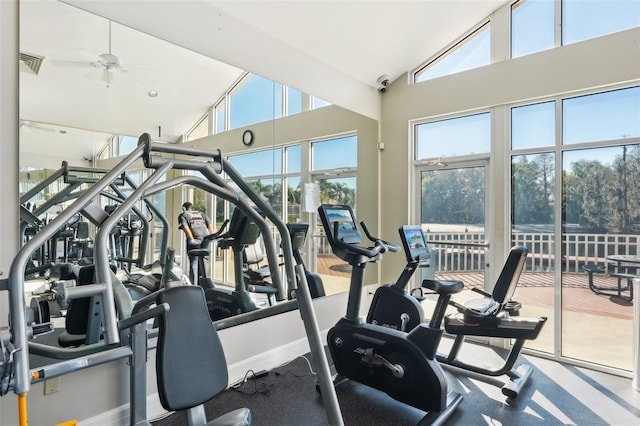 exercise room with a ceiling fan, high vaulted ceiling, and visible vents