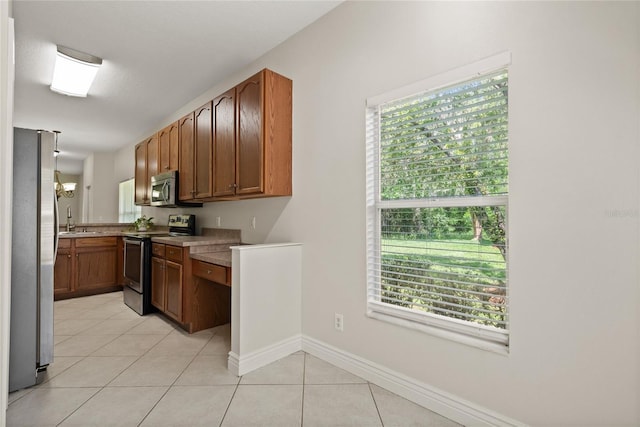 20221 Vintage Oaks Pl, Tampa, FL 33647 - kitchen featuring appliances with stainless steel finishes, a sink, healthy amount of natural light, and light tile patterned floors