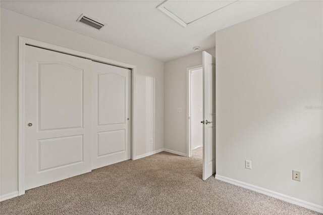20221 Vintage Oaks Pl, Tampa, FL 33647 - unfurnished bedroom with light carpet, baseboards, a closet, and attic access