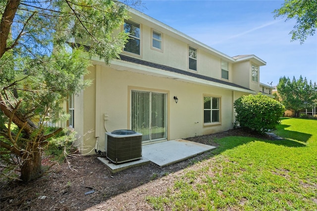20221 Vintage Oaks Pl, Tampa, FL 33647 - back of house featuring stucco siding, central AC unit, and a yard