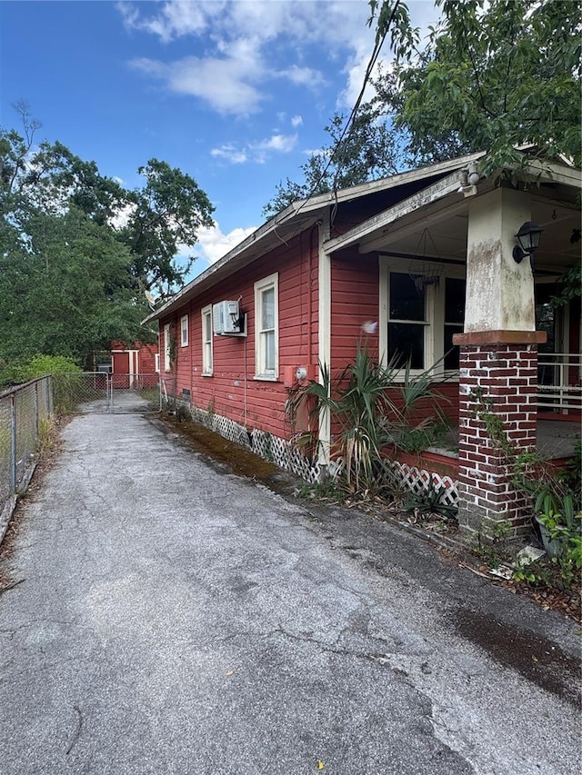 view of property exterior featuring fence and driveway