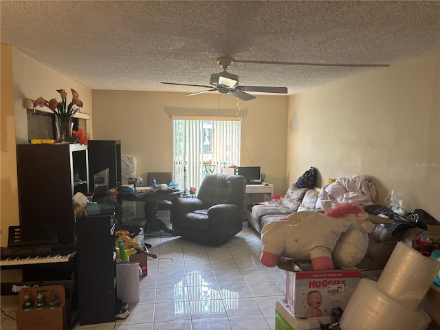 living area with light tile patterned flooring, a ceiling fan, and a textured ceiling