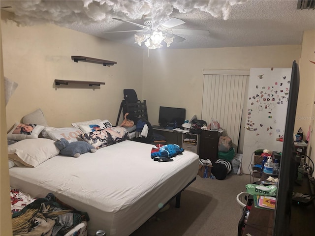 carpeted bedroom featuring a ceiling fan, a textured ceiling, and visible vents