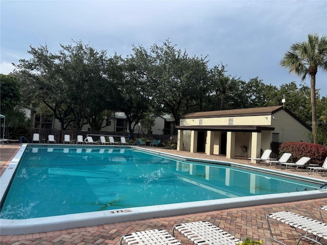 pool featuring a patio and fence
