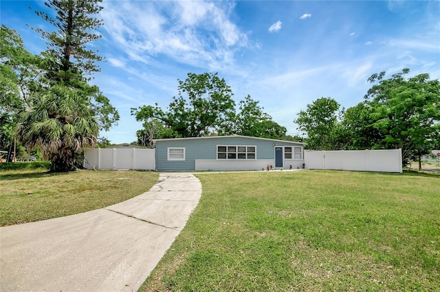 6601 13th St N, Saint Petersburg, FL 33702 - view of front of property with fence, concrete driveway, and a front yard