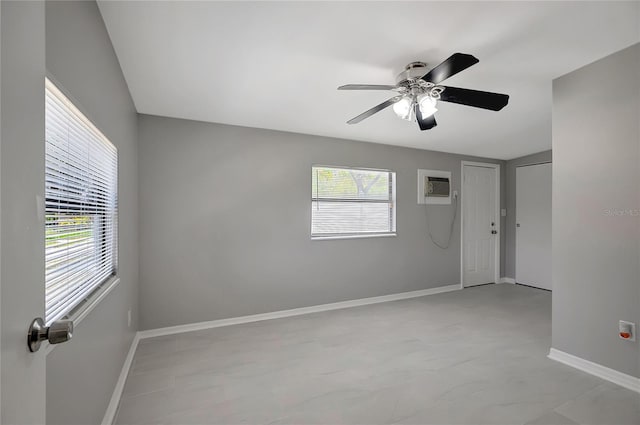 6601 13th St N, Saint Petersburg, FL 33702 - unfurnished room with baseboards, a wall unit AC, and a ceiling fan