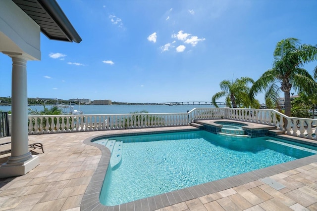 view of pool featuring a water view and a pool with connected hot tub