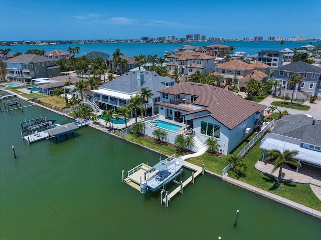 birds eye view of property featuring a water view and a residential view