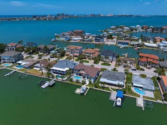 drone / aerial view featuring a residential view and a water view