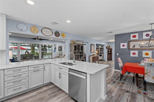 297 Lakeview Dr, Tarpon Springs, FL 34689 - kitchen with dishwasher, a sink, light wood finished floors, light countertops, and open floor plan