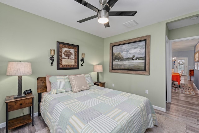 297 Lakeview Dr, Tarpon Springs, FL 34689 - bedroom with wood finished floors, baseboards, and a ceiling fan