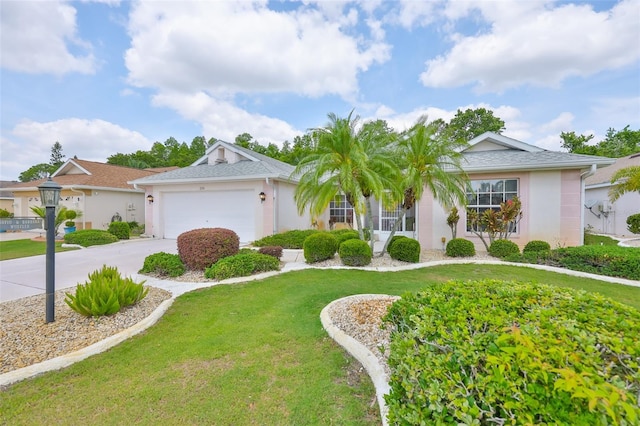 ranch-style house with an attached garage, driveway, a front yard, and stucco siding