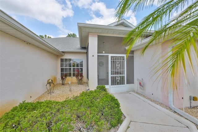 doorway to property with stucco siding