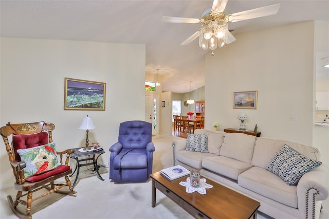 carpeted living area featuring a ceiling fan and lofted ceiling