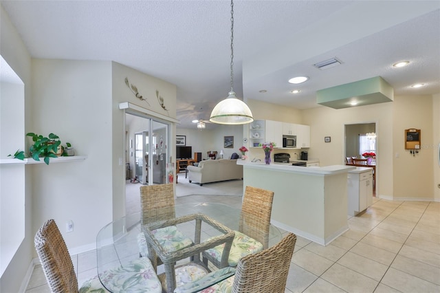 dining room with french doors, a textured ceiling, visible vents, baseboards, and light tile patterned flooring