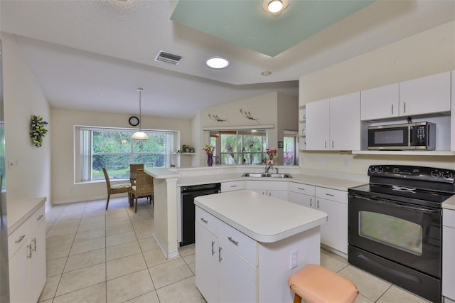 kitchen featuring visible vents, a sink, light countertops, black appliances, and white cabinetry