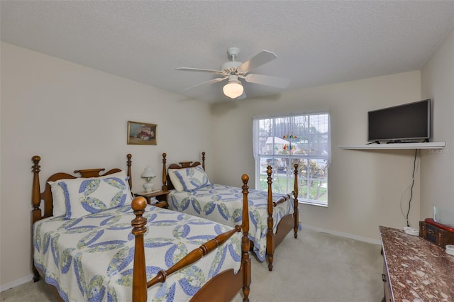 bedroom with light colored carpet, a ceiling fan, and baseboards