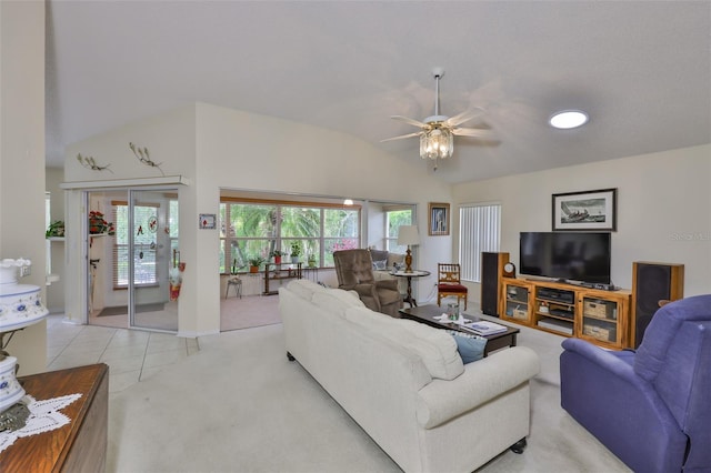 living area with a ceiling fan, light carpet, light tile patterned floors, and lofted ceiling