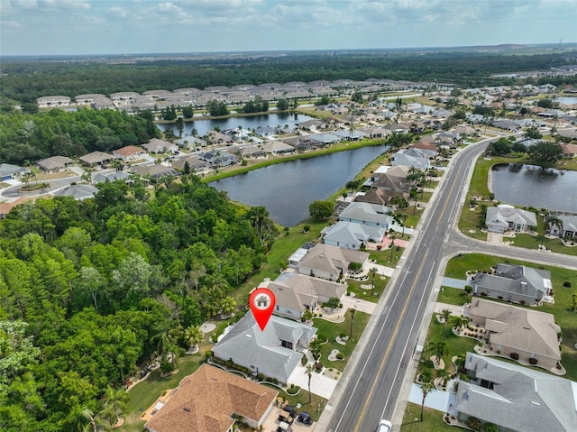 drone / aerial view with a water view and a residential view