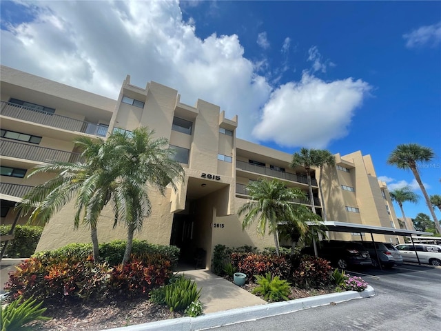 view of building exterior featuring covered parking