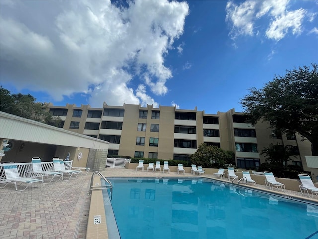 community pool featuring a patio and fence
