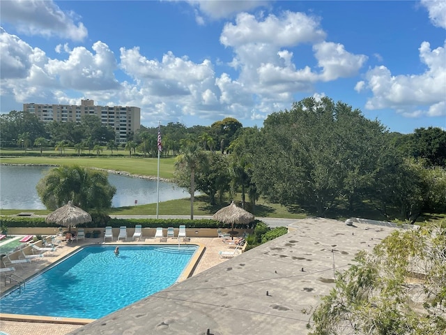 community pool featuring a patio and a water view