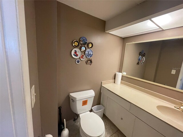 half bath featuring vanity and toilet