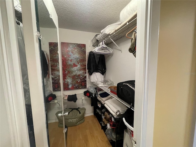 spacious closet with wood finished floors