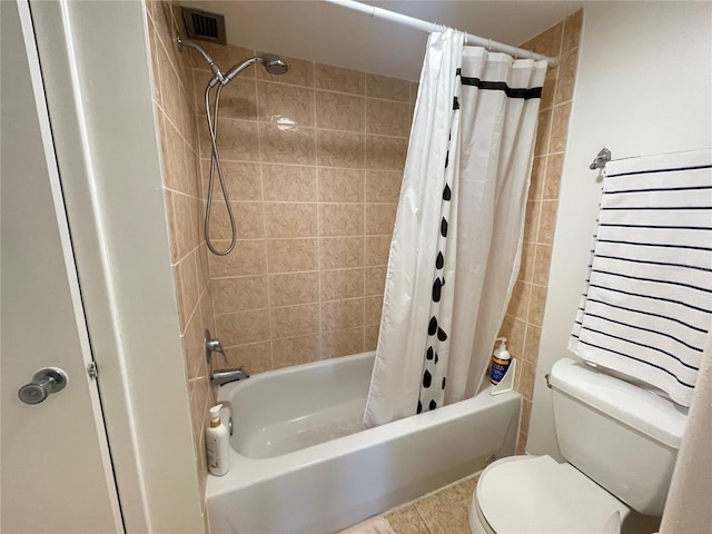 bathroom with tile patterned flooring, toilet, visible vents, and shower / tub combo with curtain