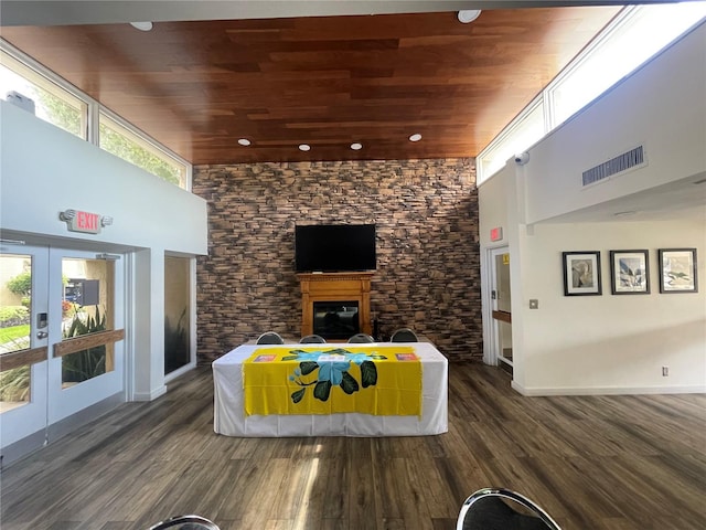 reception area featuring visible vents, a glass covered fireplace, and french doors