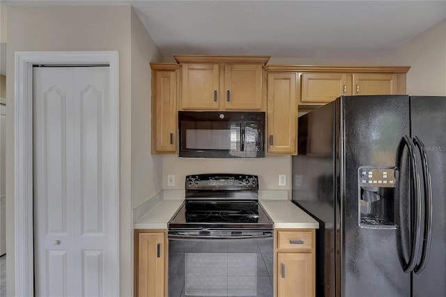 kitchen with light countertops, light brown cabinetry, and black appliances