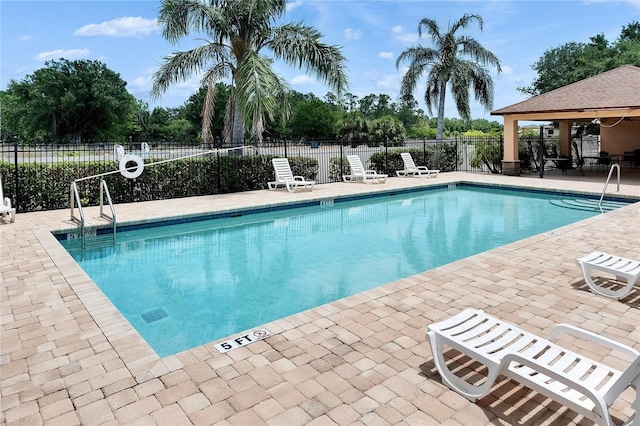 pool featuring a patio and fence