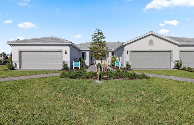 single story home with stucco siding, a front lawn, and a garage