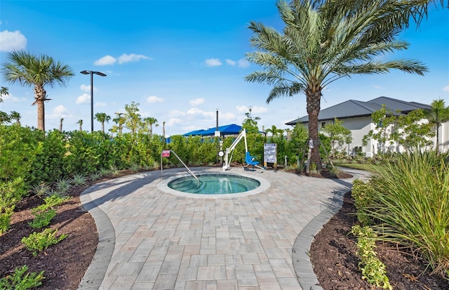 view of swimming pool featuring a community hot tub