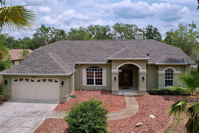 5058 Westlake Blvd, Dade City, FL 33523 - ranch-style house with a garage, brick siding, and roof with shingles