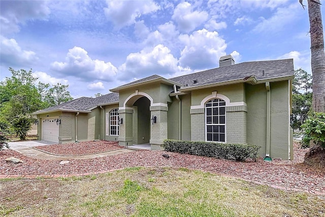 5058 Westlake Blvd, Dade City, FL 33523 - view of front of home featuring stucco siding, a chimney, and a garage