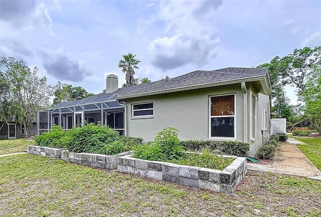5058 Westlake Blvd, Dade City, FL 33523 - view of home's exterior with stucco siding, a chimney, and a yard