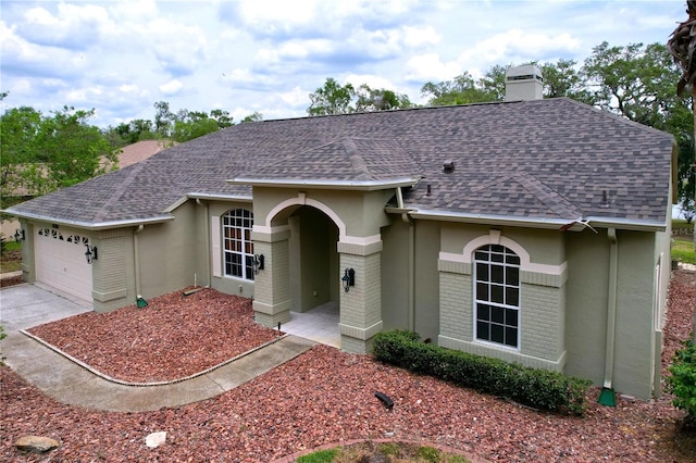 5058 Westlake Blvd, Dade City, FL 33523 - ranch-style home featuring a shingled roof, a chimney, an attached garage, concrete driveway, and stucco siding