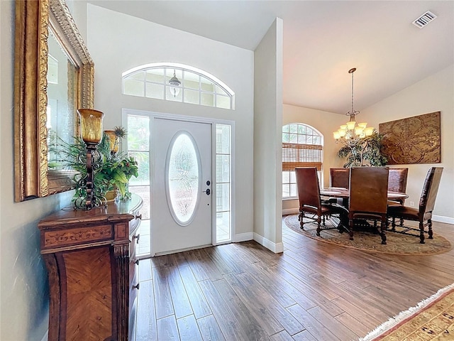 5058 Westlake Blvd, Dade City, FL 33523 - entryway with wood finished floors, a chandelier, baseboards, and high vaulted ceiling