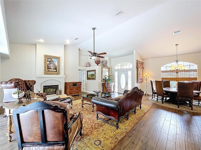 5058 Westlake Blvd, Dade City, FL 33523 - living room with plenty of natural light, vaulted ceiling, wood finished floors, a chandelier, and a glass covered fireplace