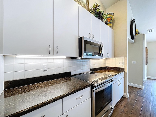 5058 Westlake Blvd, Dade City, FL 33523 - kitchen featuring stainless steel appliances, dark wood finished floors, tasteful backsplash, white cabinets, and baseboards