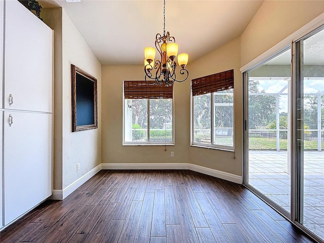 5058 Westlake Blvd, Dade City, FL 33523 - unfurnished dining area with baseboards, dark wood finished floors, and a chandelier