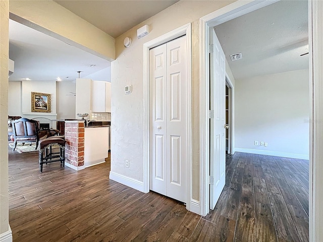5058 Westlake Blvd, Dade City, FL 33523 - corridor with dark wood finished floors and baseboards