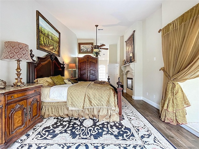 5058 Westlake Blvd, Dade City, FL 33523 - bedroom with wood finished floors, baseboards, and a glass covered fireplace