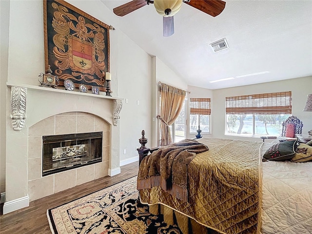 5058 Westlake Blvd, Dade City, FL 33523 - bedroom featuring wood finished floors, a fireplace, a ceiling fan, lofted ceiling, and baseboards