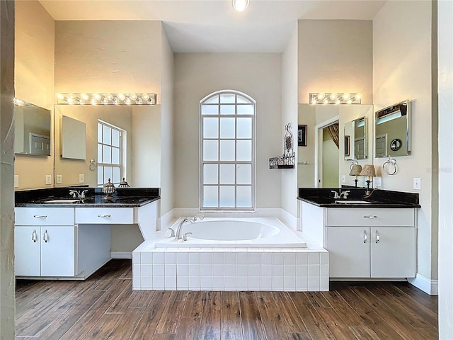 5058 Westlake Blvd, Dade City, FL 33523 - full bathroom featuring wood finished floors, a bath, and two vanities