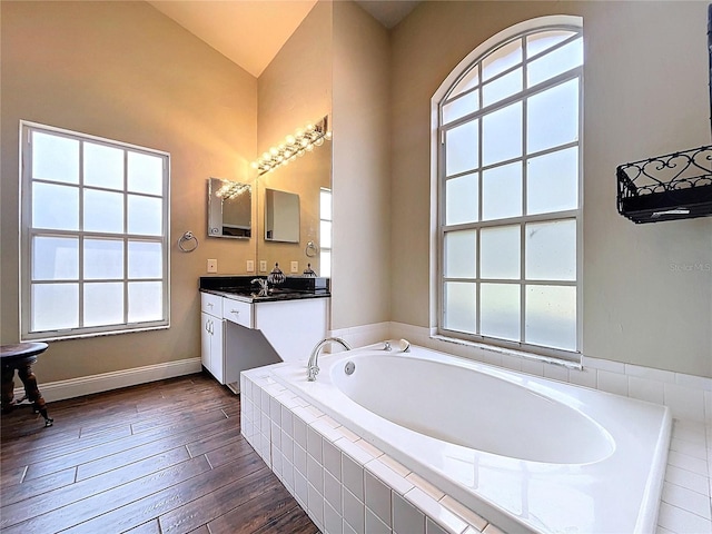 5058 Westlake Blvd, Dade City, FL 33523 - full bathroom featuring a bath, vaulted ceiling, vanity, and wood finished floors
